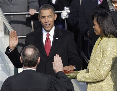 Barack Obama, left, joined by his wife Michelle, takes the oath of office from Chief Justice John Roberts to become the 44th president of the United States at the U.S. Capitol in Washington, Tuesday, Jan. 20, 2009. <br/>Photo: AP Images / Jae C. Hong