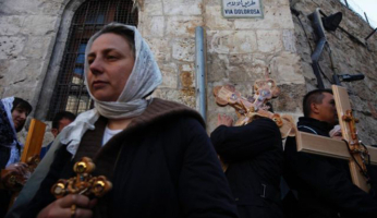 Christian worshippers carry crosses as they take part in the Eastern and Orthodox Church's Good Friday procession in the Old City of Jerusalem April 13, 2012. Photo by Reuters <br/>