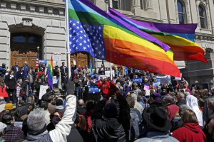 Demonstrators against Indiana's Religious Freedom Restoration Act in Indianapolis fly a gay rainbow flag upside down in a distress signal. <br/>Reuters
