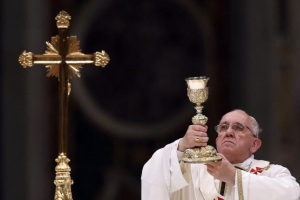 Pope Francis lifts up the chalice as he leads a vigil mass during Easter celebrations at St. Peter's Basilica in the Vatican April 19, 2014. REUTERS/ALESSANDRO BIANCHI <br/>