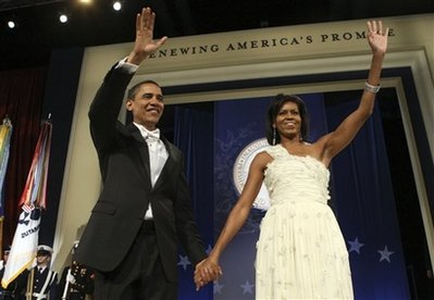 President Barack Obama, right, and first lady Michelle Obama wave as they arrive at the Western Ball in Washington, Wednesday, Jan. 21, 2009. <br/>(AP Photo/Pablo Monsavais)