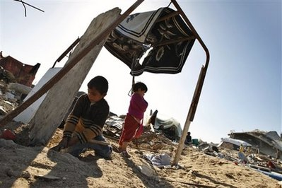 Palestinian children play under a makeshift shelter as their family rests on the rubble of their destroyed house in the eastern part of Jebaliya, northern Gaza Strip, Tuesday, Jan. 27, 2009. <br/>(Photo: AP Images / Khalil Hamra)