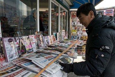 A Chinese man looks at a Chinese daily bearing the Inauguration of U.S. President Barack Obama on its cover in Beijing, China, Wednesday, Jan. 21, 2009. Chinese translations of President Barack Obama's inauguration speech were missing his references to communism and dissent. The comments by the newly installed U.S. president veered into potentially sensitive territory for China's ruling Communist Party, which maintains a tight grip over the Internet and the entirely state-run media. <br/>(Photo: AP Images / Elizabeth Dalziel)