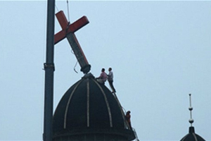 ''To continue to forcefully remove and ban the cross on the rooftop of the church buildings demonstrates the Chinese regime's determination to contain the rapid growth of Christianity in China,'' says Bob Fu. Photo: AP <br/>