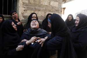 Relatives and neighbors of Egyptian Coptic Christians who were killed in Libya mourn outside one of their houses in a village in the Minya governorate, south of Cairo earlier this year. <br/>Reuters
