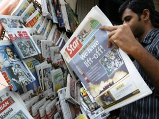 A newspaper reader in Kuala Lumpur. <br/>(Photo: AP Images / Lai Seng Sin, File)