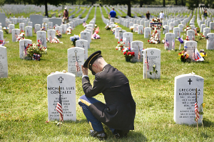 At Arlington National Cemetery, Sgt. Brian Scott, 30, with the 18th Military Police Brigade, visits the grave of his friend. <br/>AP Photo