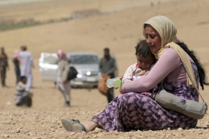 A displaced woman and child flee violence from ISIS in Sinjar, Iraq. <br/>CNS Photo