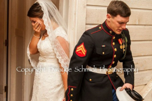 US Marine Corps Corporal Caleb Earwood (R) and his fiancee Maggie (L), both from Asheville, North Carolina, were photographed saying a prayer just moments before they walked down the aisle <br />
 <br/>Dwayne Schmidt Photography