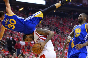Warriors guard Stephen Curry (30) falls over Rockets forward Trevor Ariza during the first half of Game 4 of the Western Conference finals at the Toyota Center in Houston. (Photo: LARRY W. SMITH, EPA) <br/>