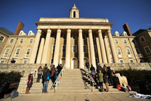 Protestors stand in silence against the Kappa Delta Rho fraternity, in front of Penn State University's Old Main building, in University Park, Pa., Monday, March 23, 2015. Photo: AP <br/>