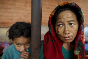 Chij Maya Gurung, 35, (R) and her daughter Nita Gurung, 10, sit outside the Gorkha hospital after arriving by helicopter from their village in Gorkha, Nepal April 30, 2015. <br/> REUTERS/Athit Perawongmetha