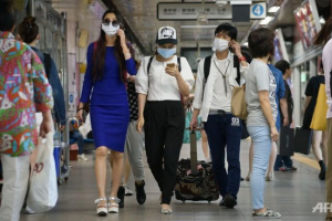 People wearing face masks walk through a subway station in the popular Myeongdong shopping area in Seoul on June 4, 2015. (Photo: AFP/Ed Jones) <br/>
