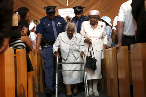 Jeralean Talley, the world's oldest-known living person, is escorted down the aisle following a church service and celebration for her 116th birthday in Inkster, Michigan May 24, 2015. REUTERS/Rebecca Cook  <br/>