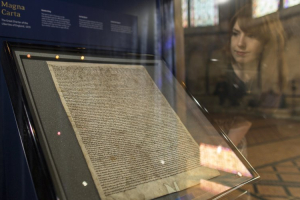 Meg Bullock of Salisbury Cathedral poses for photographers as she looks at the Salisbury Magna Carta. Kieran Doherty/Reuters <br/>
