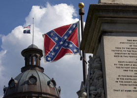 The U.S. flag and South Carolina state flag flies at half staff to honor the nine people killed in the Charleston murders as the confederate battle flag also flies on the grounds of the South Carolina State House in Columbia, SC June 20, 2015. REUTERS/Jason Miczek <br/>