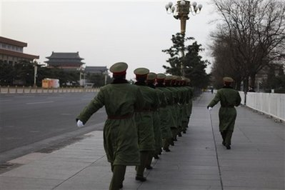 Rings of uniformed and plainclothes police seal off Tiananmen and keep ordinary Chinese and the normal hordes of tourists away for the annual session of the National People's Congress final day in Beijing, China, Friday, March 13, 2009. <br/>(Photo: AP Images / Elizabeth Dalziel)