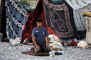 A Syrian refugee man from the northern Syrian town of Tel Abyad prays in front of his makeshift tent in Akcakale, in Sanliurfa province, Turkey, June 18, 2015.  <br/>Reuters