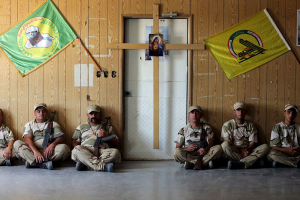 Iraqi Christians volunteers, who have joined Hashid Shaabi (Popular Mobilization), allied with Iraqi forces against the Islamic State, rest during training in a military camp in Baghdad, July 1, 2015. REUTERS/Stringer <br/>
