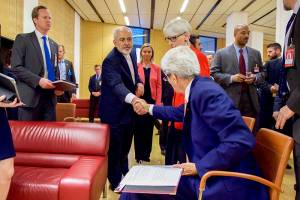U.S. Secretary of State John Kerry (seated) shakes hands with Iranian Foreign Minister Javad Zarif as he prepares to leave the Austria Center in Vienna, Austria, July 14, 2015. Iran and six major world powers reached a nuclear deal on Tuesday, capping more than a decade of on-off negotiations with an agreement that could potentially transform the Middle East, and which Israel called an 
