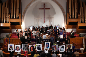 Photographs of the nine victims killed at the Emanuel African Methodist Episcopal Church in Charleston, South Carolina are held up by congregants during a prayer vigil at the the Metropolitan AME Church June 19, 2015 in Washington, DC. Earlier today the suspect in the case, Dylan Storm Roof, was charged with nine counts of murder. Win McNamee/Getty Images North America <br/>