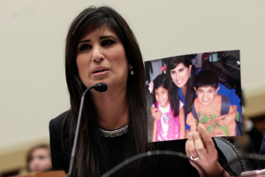 Naghmeh Abedini holds up a picture of her husband, Pastor Saeed Abedini, and her two children, Jacob and Rebecca. <br/>AP photo