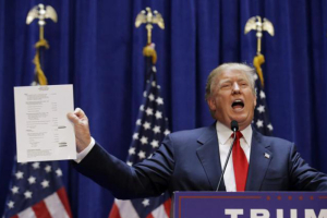Republican presidential candidate, real estate mogul and TV personality Donald Trump holds up his financial statement showing his net worth as he formally announces his campaign for the 2016 Republican presidential nomination during an event at Trump Tower in New York. Reuters/Brendan McDermid <br/>