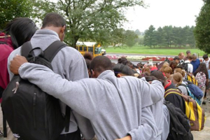 Students huddle together in prayers at the annual See You at the Pole event. Photo: SYATP <br/>