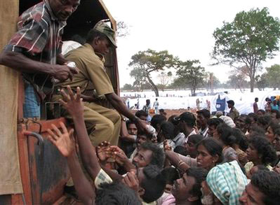 Internally displaced Sri Lankan ethnic Tamil civilians gather around a truck to receive food at a camp for the displaced in Manic Farm in Vavuniya, Sri Lanka, Sunday, April 26, 2009. <br/>(Photo: AP / Sanath Priyantha)