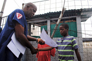 Moses Duo, 9, receives a certificate for being cured of the Ebola virus in Paynesville, Liberia, July 20, 2015. The last four cases of Ebola in Liberia were discharged from a treatment clinic on Monday, meaning there were no more confirmed carriers of the deadly virus in the West African country. REUTERS/James Giahyue <br/>
