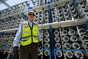 Poseidon Water project manager Peter MacLaggen stands next to some of the reverse osmosis filters as work continues on the Western Hemisphere's largest seawater desalination plant in Carlsbad, California, April 14, 2015. Desalination has emerged as a newly promising technology in California in the face of a record dry spell that has forced tough new conservation measures, depleted reservoirs and raised the costs of importing fresh water from elsewhere. The biggest ocean desalination plant in the Western Hemisphere, a $1 billion project under construction since 2012 on a coastal lagoon in the California city of Carlsbad, is nearly completed and due to open in November, delivering up to 50 million gallons of water a day to San Diego County. REUTERS/Mike Blake <br/>