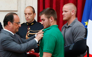 Francois Hollande awards Alek Skarlatos with the Legion d'Honneur (the Legion of Honor) medal. <br/>REUTERS/Michel Euler