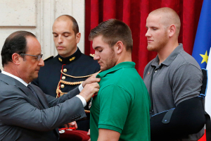 Francois Hollande awards Alek Skarlatos with the Legion d'Honneur (the Legion of Honor) medal. <br/>REUTERS/Michel Euler