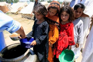 Displaced children from Pakistani troubled Swat Valley queue for food in Shiekh Yasin camp in Mardan, Pakistan on Wednesday, June 3, 2009. The military offensive to expel the Taliban from Pakistan's Swat Valley could take another two months to complete, and troops may have to stay for a year to prevent militants from retaking control, commanders said Wednesday. <br/>(Photo: AP / Mohammad Sajjad)