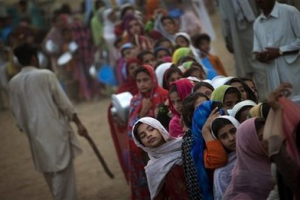 Displaced girls line up as they wait for the daily ration during a food distribution at the Chota Lahore refugee camp, at Swabi, in northwest Pakistan, Monday, June 1, 2009. <br/>(Photo: AP Images / Emilio Morenatti)