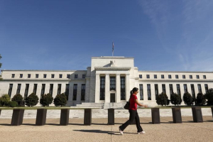 A woman walks past the Federal Reserve headquarters in Washington September 16, 2015. REUTERS/Kevin Lamarque <br/>