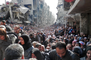 Residents wait in line to receive food aid distributed in the Yarmouk refugee camp in Damascus, Syria <br/>Reuters