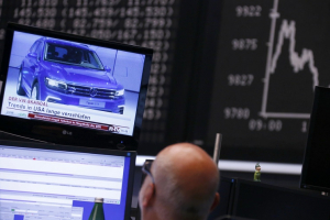 A Volkswagen Tiguan car appears in a news broadcast on a TV in front of the German share price index DAX board, at the stock exchange in Frankfurt, Germany September 21, 2015. REUTERS/Ralph Orlowski <br/>