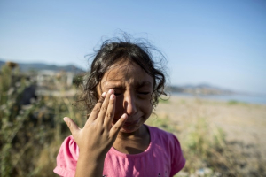 Yasmine, a 6-year-old migrant from Deir Al Zour in war-torn Syria, cries at the beach after arriving on the Greek island of Lesbos in this file photo taken September 11, 2015. REUTERS/Zohra Bensemra/Files <br/>