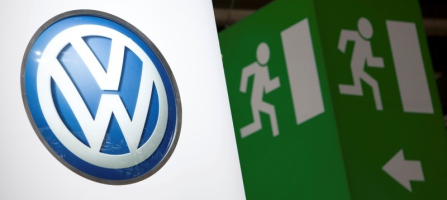 Volkswagen logo is seen next to an emergency exit sign on the company's booth during the first media day of the Geneva Auto Show at the Palexpo in Geneva, in this March 6, 2012 file photo. REUTERS/Valentin Flauraud/Files <br/>