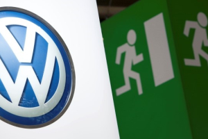 Volkswagen logo is seen next to an emergency exit sign on the company's booth during the first media day of the Geneva Auto Show at the Palexpo in Geneva, in this March 6, 2012 file photo. REUTERS/Valentin Flauraud/Files <br/>