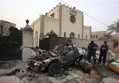 Iraqi police stand outside a Christian church the morning after a car bomb attack in Baghdad, Iraq, Monday, July 13, 2009. The bomber struck just as worshippers left Sunday Mass, one of several attacks in Christians in the Iraqi capital that left at least four dead. <br/>(Photo: AP Images / Karim Kadim)