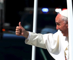 Pope Francis gives a thumbs up to the crowd as he rides down Constitution Avenue in his Popemobile in Washington on day two of his first visit to the United States in Washington September 23, 2015. REUTERS/Gary Cameron <br/>