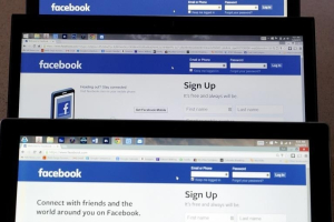 Computer screens display the Facebook sign-in screen in this photo illustration taken in Golden, Colorado July 28, 2015. REUTERS/Rick Wilking <br/>