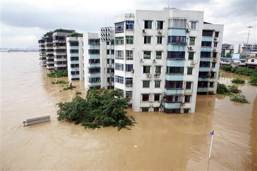 Flood waters submerge parts of residential buildings along the river in Liuzhou in south China's Guangxi region Saturday July 4, 2009. Hundreds of thousands have been evacuated from homes in southern and central China after heavy rains toppled houses, flooded roads and damaged a dam. <br/>