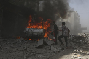 Residents try to put out a fire at a site after what activists said were two air strikes by forces of Syria's President Bashar al-Assad on a market in central Douma, eastern al-Ghouta, near Damascus September 17, 2014.  <br/>BASSAM KHABIEH/REUTERS