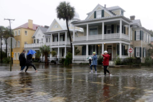 People cross a flooded street in Charleston, S.C., Saturday, Oct. 3, 2015. <br/>AP photo