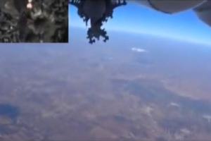 A frame grab taken from footage from a camera under a plane released by Russia's Defence Ministry October 5, 2015, shows a Russian military jet flying after dropping bombs, as a miniature screen (L, top) displays the explosions on the ground during an airstrike, near Idlib in Syria.  <br/>REUTERS/Ministry of Defence of the Russian Federation/Handout via Reuters