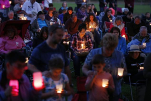 People bow their heads in prayer during a vigil Saturday in Winston, Ore.  <br/>AP photo