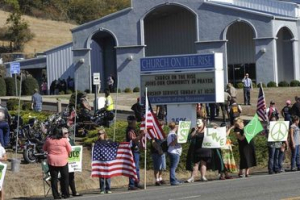 Supporters line the street outside the Church on the Rise as people arrive at the funeral service of Umpqua Community College student Jason Johnson in Roseburg, Oregon October 8, 2015.  <br/>REUTERS/Amanda Loman